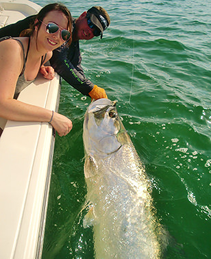 Happy woman with tarpon caught off Boca Grande with Captain Jesse.