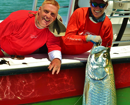 Capt. Kelly holding a very large tarpon caught on a fishign charter in Boca Grande.