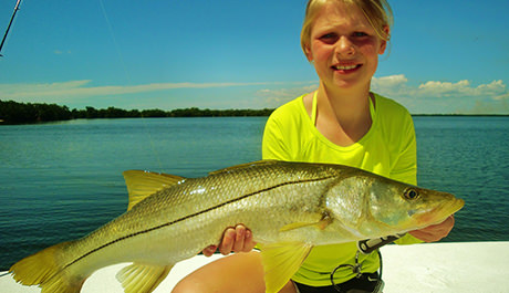 Girl holding large snook caught with Capt. Jesse and Capt. Kelly in Englewood, Florida.